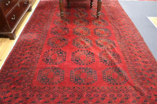 An Afghan red ground rug, 235 x 340cm